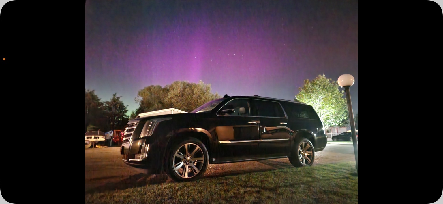 Black Night Limo Cadillac Escalade beneath a purple night sky